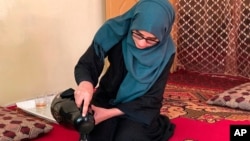 Salgy Baran, 18, who received the highest the highest score in the entire country on Afghanistan's university entrance exams this year, pours tea inside her home in Kabul, Afghanistan, Aug. 26, 2021.