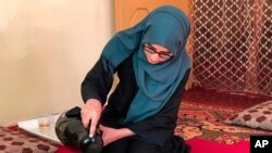 Salgy Baran, 18, who received the highest the highest score in the entire country on Afghanistan's university entrance exams this year, pours tea inside her home in Kabul, Afghanistan, Aug. 26, 2021.