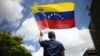 FILE - A man waves a Venezuelan flag in Caracas on Aug. 17, 2024. 