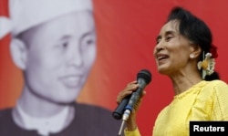 FILE - Myanmar pro-democracy leader Aung San Suu Kyi gives a speech during her campaign rally for the upcoming general election in her constituency Kawhmu township, Yangon Division, Oct. 24, 2015.