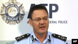 Australian Federal Police Deputy Commissioner Michael Phelan speaks to the media that two Sydney men have been arrested by the Joint Counter Terrorism team in Sydney, Australia, Wednesday, Dec. 24, 2014.