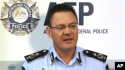 Australian Federal Police Deputy Commissioner Michael Phelan speaks to the media that two Sydney men have been arrested by the Joint Counter Terrorism team in Sydney, Australia, Wednesday, Dec. 24, 2014.