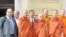 Thach Ngoc Thach, left and newly re-ordained monk Tim Sakhorn, middle, drops by VOA Khmer while on a visit in the US, file photo. 