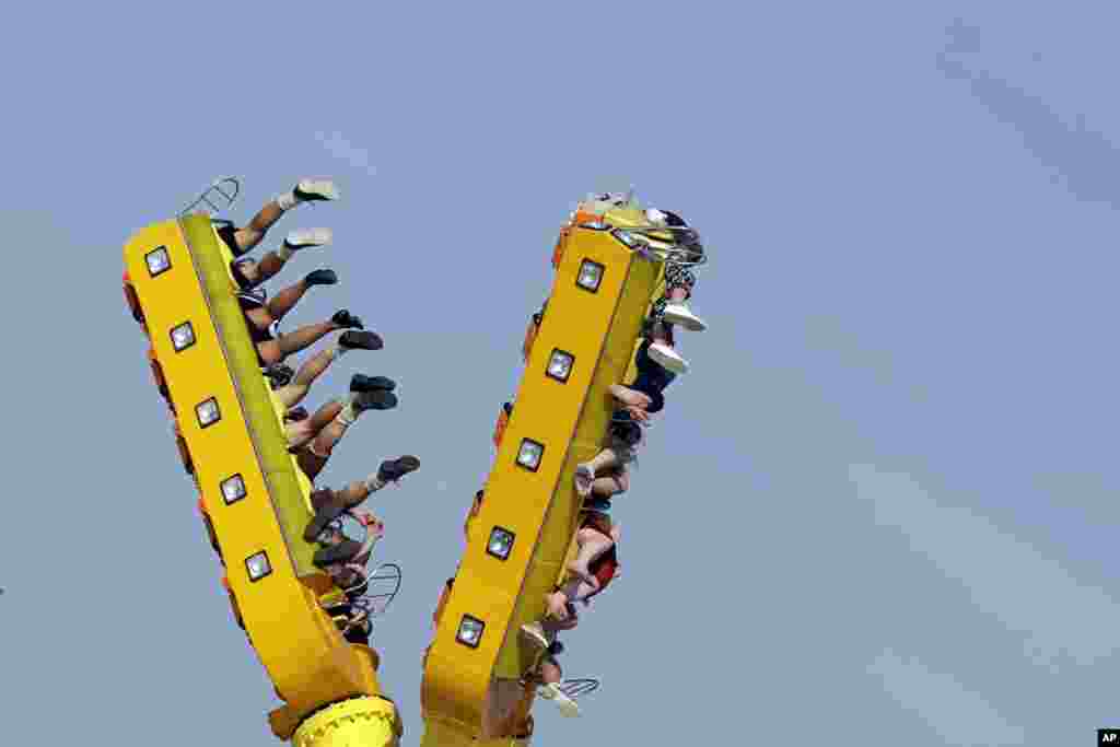 People enjoy a fairground ride at the 183rd Oktoberfest beer festival in Munich, Germany.