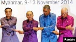 Left to right, China's Premier Li Keqiang, Myanmar's President Thein Sein, U.S. President Barack Obama and Malaysia's Prime Minister Najib Razak hold hands as they pose for family photo before the gala dinner at the 25th ASEAN Summit in Myanmar.