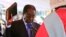 Zimbabwean President Robert Mugabe holds the bible during his inauguration, Harare, Aug. 22, 2013.
