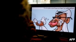 A woman looks at a caricature by Jordanian cartoonist Emad Hajjaj depicting UAE leader Sheikh Mohammed bin Zayed Al-Nahyan, holding a dove with Israel's flag on it spitting in his face, in Nicosia, Cyprus, Aug. 27, 2020.