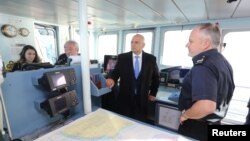 FILE - British Home Secretary Sajid Javid meets Border Force staff on board the HMC Searcher in Dover, Britain, Jan. 2, 2019. 