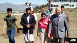 Pakistani activist and Nobel Peace Prize laureate Malala Yousafzai, center, arrives along with her father Ziauddin Yousafzai, second left, brother Atal Yousafzai, left, and the principal of all-boys Swat Cadet College Guli Bagh, during her hometown visit, March 31, 2018. 