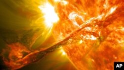 A NASA image captured by NASA’s Solar Dynamics Observatory shows a blast of plasma streaming from the sun in August 2012.