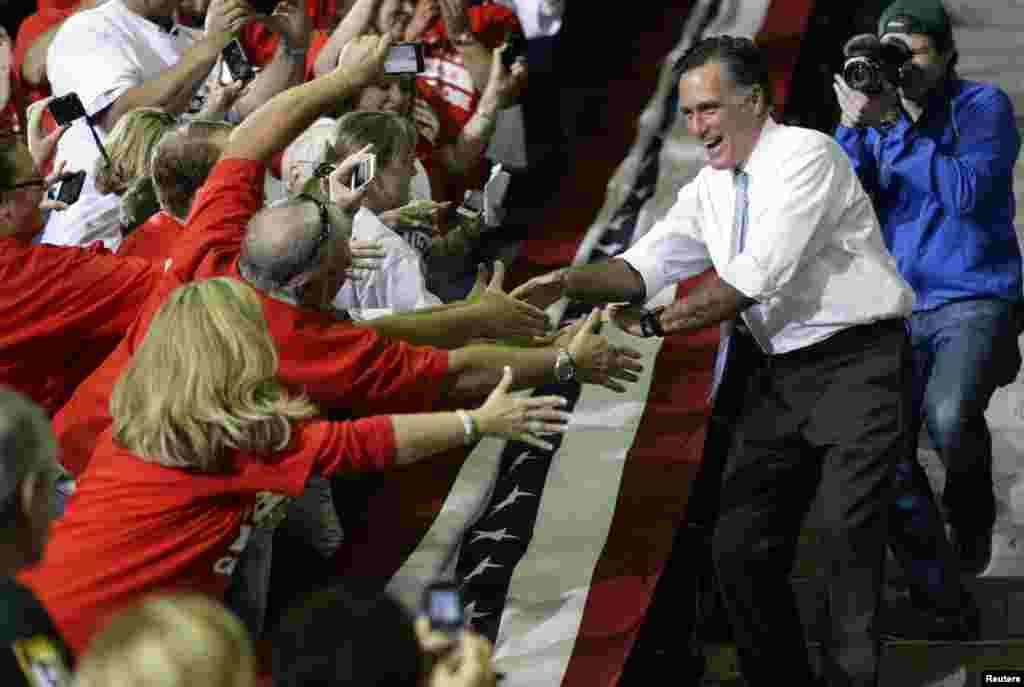 Republican presidential candidate and former Massachusetts Gov. Mitt Romney greets supporters as he campaigns at the Pensacola Civic Center in Pensacola, Florida, Oct. 27, 2012.