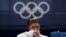 Simone Biles, of the United States, watches gymnasts perform at the 2020 Summer Olympics, July 27, 2021, in Tokyo. 