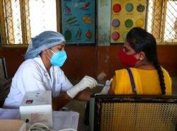 Seorang petugas kesehatan memberikan vaksin Covishield selama program vaksinasi khusus melawan COVID-19 di Hyderabad, India, 29 Juni 2021. (Foto: AP)