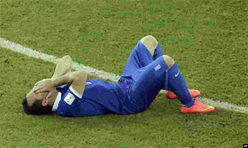 Greece's Fanis Gekas sits on the floor after failing to score from the penalty spot during the World Cup round of 16 soccer match between Costa Rica and Greece at the Arena Pernambuco in Recife, Brazil, Sunday, June 29, 2014. Costa Rica won 5-3 on penalti