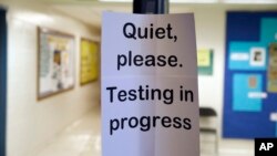 FILE - In this Jan. 17, 2016 file photo, a sign is seen at the entrance to a hall for a college test preparation class in Bethesda, Md. 