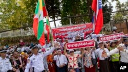 FILE - Police officers try to direct traffic as members of a Buddhist nationalist group protest outside the U.S. Embassy in Yangon, Myanmar, April 28, 2016. Former U.N. Secretary-General Kofi Annan will head a commission to discuss the ethnic conflict and clashes in Myanmar's Rakhine state.