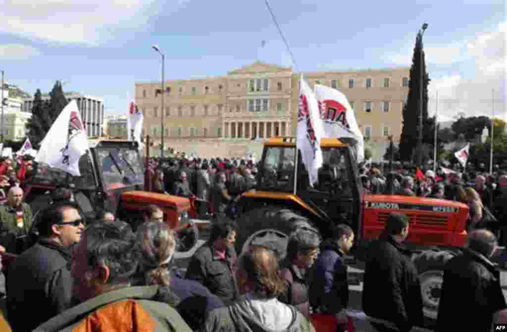 Farmers drive their tractors as protesters gather during a rally outside the Greek Parliament in Athens, Wednesday, Feb. 23, 2011. More than 30,000 protesters attended the Athens rally, which had been calm before the clashes. Protesters chanting "Don't ob