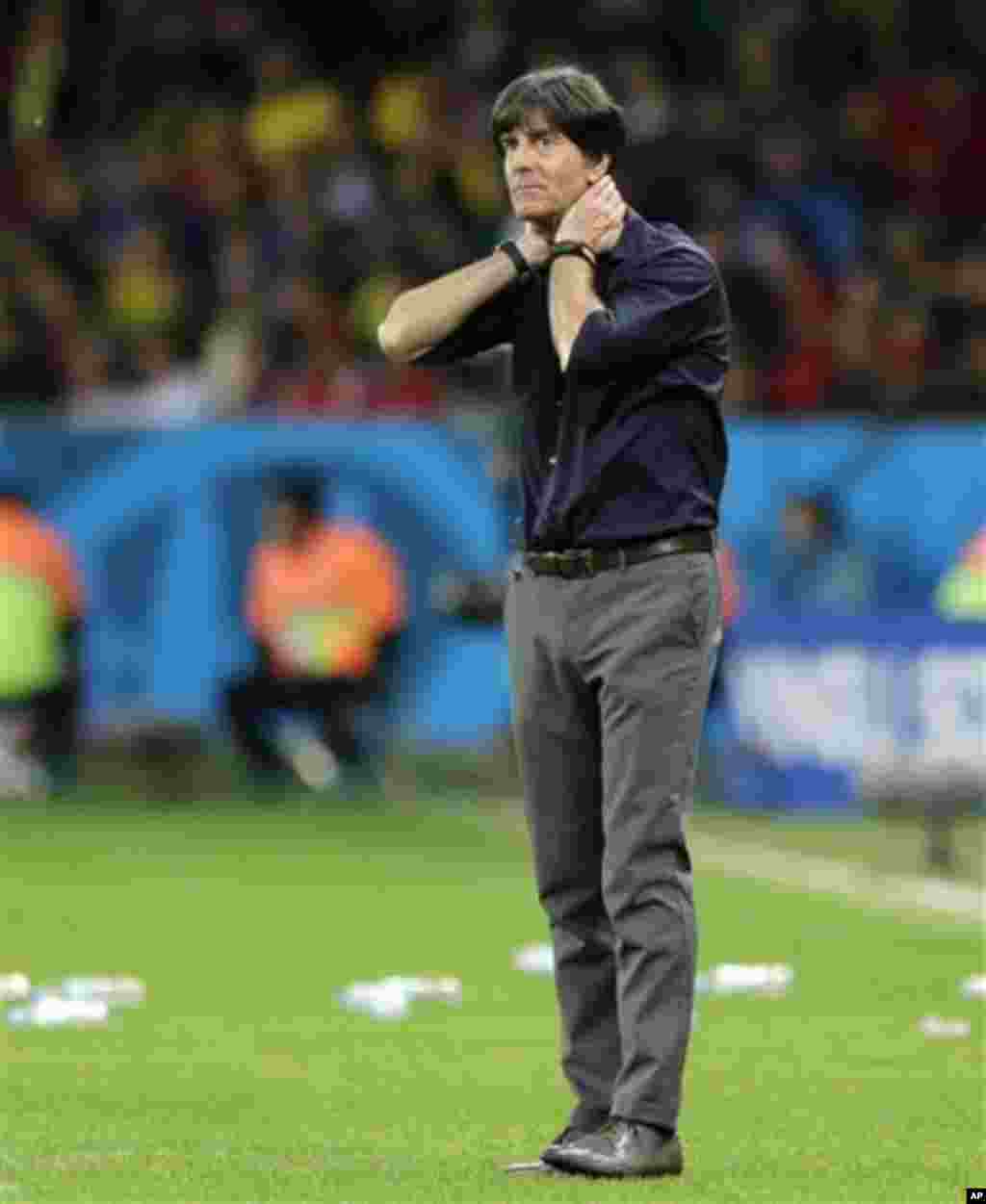 Germany's head coach Joachim Loew watches his team from the sidelines during the World Cup round of 16 soccer match between Germany and Algeria at the Estadio Beira-Rio in Porto Alegre, Brazil, Monday, June 30, 2014. (AP Photo/Matthias Schrader)