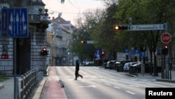 A man crossing a street as Croatia is stepping up measures to fight the coronavirus disease (COVID-19) outbreak, in Zagreb, Croatia March 21, 2020. REUTERS/Antonio Bronic/