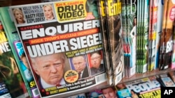 FILE - The cover of an issue of the National Enquirer is shown, featuring President Donald Trump at a store in New York, July 12, 2017. 