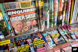 FILE - The cover of an issue of the National Enquirer is shown, featuring President Donald Trump at a store in New York, July 12, 2017.