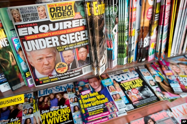 FILE - The cover of an issue of the National Enquirer is shown, featuring President Donald Trump at a store in New York, July 12, 2017.