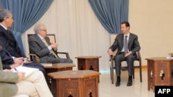 A handout picture released by the official Syrian Arab News Agency (SANA) on Oct. 30, 2013, shows Syrian President Bashar al-Assad (R) and Ministers meeting with U.N.-Arab League peace envoy Lakhdar Brahimi (2ndR) in Damascus. 