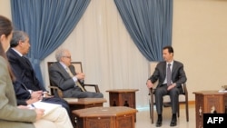 A handout picture released by the official Syrian Arab News Agency (SANA) on Oct. 30, 2013, shows Syrian President Bashar al-Assad (R) and Ministers meeting with U.N.-Arab League peace envoy Lakhdar Brahimi (2ndR) in Damascus.