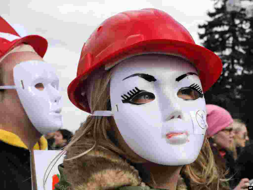 Masked sex workers hold a rally in front of the Ukrainian Parliament building in Kyiv. The rally was held to demand the legalization of their work.
