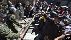 Protesters clash with police officers during a march in La Paz, Bolivia. Bolivia's Defense Minister Cecilia Chacon resigned Monday after police violently broke up Sunday a protest by indigenous and environmentalists groups who were marching towards La Paz