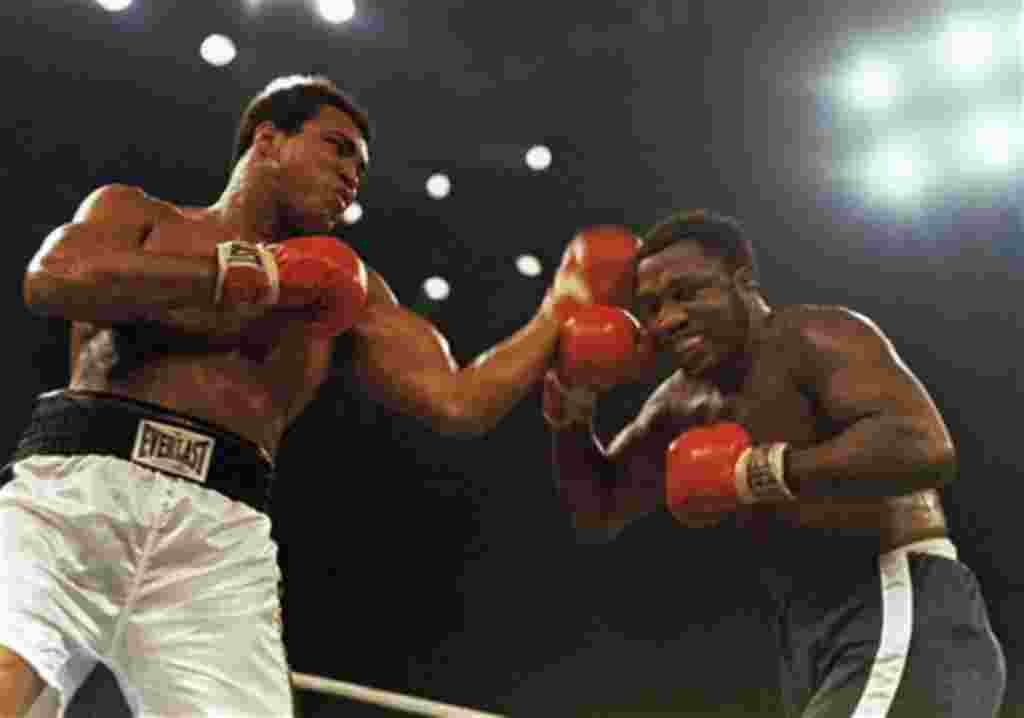 FILE - In this Jan. 28, 1974, file photo, Muhammad Ali, left, and Joe Frazier fight in a 12-round non-title fight at Madison Square Garden in New York. Former heavyweight champion Joe Frazier is seriously ill with liver cancer. His personal and business m