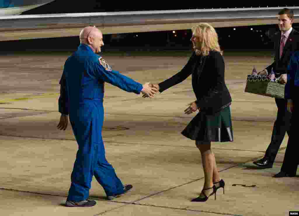 Dr. Jill Biden, wife of Vice President Joe Biden, right, greets Expedition 46 Commander Scott Kelly of NASA, left, after he landed at Ellington Field in Houston, Texas after his return to Earth.