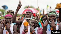 Civilians celebrate the signing of a peace agreement between Sudan's transitional government and Sudanese revolutionary movements to end decades of conflict, in Juba, South Sudan, Oct. 3, 2020. 