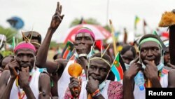 Civilians celebrate the signing of a peace agreement between Sudan's transitional government and Sudanese revolutionary movements to end decades of conflict, in Juba, South Sudan, Oct. 3, 2020. 