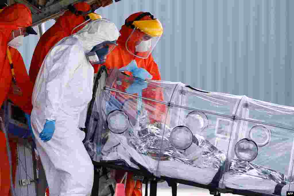 Medical staff tend to a patient infected with COVID-19 upon his arrival by plane from Osorno, Chile, Jan. 25, 2021, at a military airport in Santiago amid the novel coronavirus pandemic.