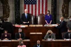 U.S. Vice President Mike Pence and Speaker of the House Nancy Pelosi (D-CA) take part in a joint session of Congress to certify the 2020 election results at the U.S. Capitol in Washington, Jan. 6, 2021.