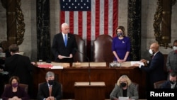 U.S. Vice President Mike Pence and Speaker of the House Nancy Pelosi (D-CA) take part in a joint session of Congress to certify the 2020 election results at the U.S. Capitol in Washington, Jan. 6, 2021. 