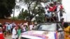 FILE - Supporters of the New Patriotic Party cheer on the street after President Nana Akufo-Addo filed his nomination forms for the 2020 presidential election at the Electoral Commission Head Office in Accra, Ghana, Oct. 6, 2020.