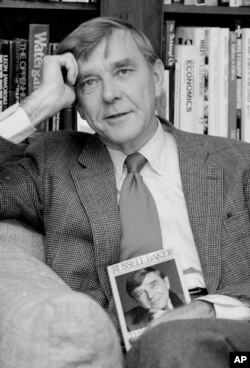 FILE - New York Times columnist and Pulitzer Prize winning author, Russell Baker, is pictured at his office at the New York Times in New York, Oct. 17, 1983.