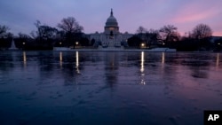 FILE - The U.S. Capitol building is seen at sunrise in Washington.