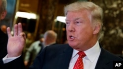 President-elect Donald Trump talks with reporters at Trump Tower in New York, Jan. 9, 2017.