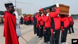 Pallbearers carry the coffins of Togo national soccer team assistant coach Abalo Amelete (front), and media officer Stanislas Ocloo during a funeral procession in Lome, Togo, 15 Jan 2010