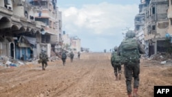 This handout picture released by the Israeli army on November 16, 2023, shows troops during a military operation in the northern Gaza Strip amid continuing battles between Israel and the Palestinian militant group Hamas.