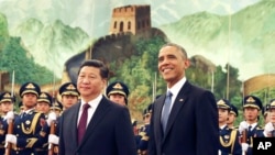 Chinese President Xi Jinping, left, and U.S. President Obama participate in a welcome ceremony for President Obama at the Great Hall of the People in Beijing, China Wednesday, Nov. 12, 2014. (AP Photo/Andy Wong)