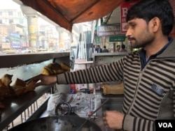 Manoj Kumar is opting for a mobile payment channel after suffering a huge dip in business due to cash shortages. (A. Pasricha/VOA)