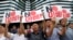 South Korean protesters hold up cards during a rally against Japan in front of a building that houses the Japanese embassy in Seoul, South Korea, Aug. 2, 2019. The signs read " Japanese Prime Minister Shinzo Abe."