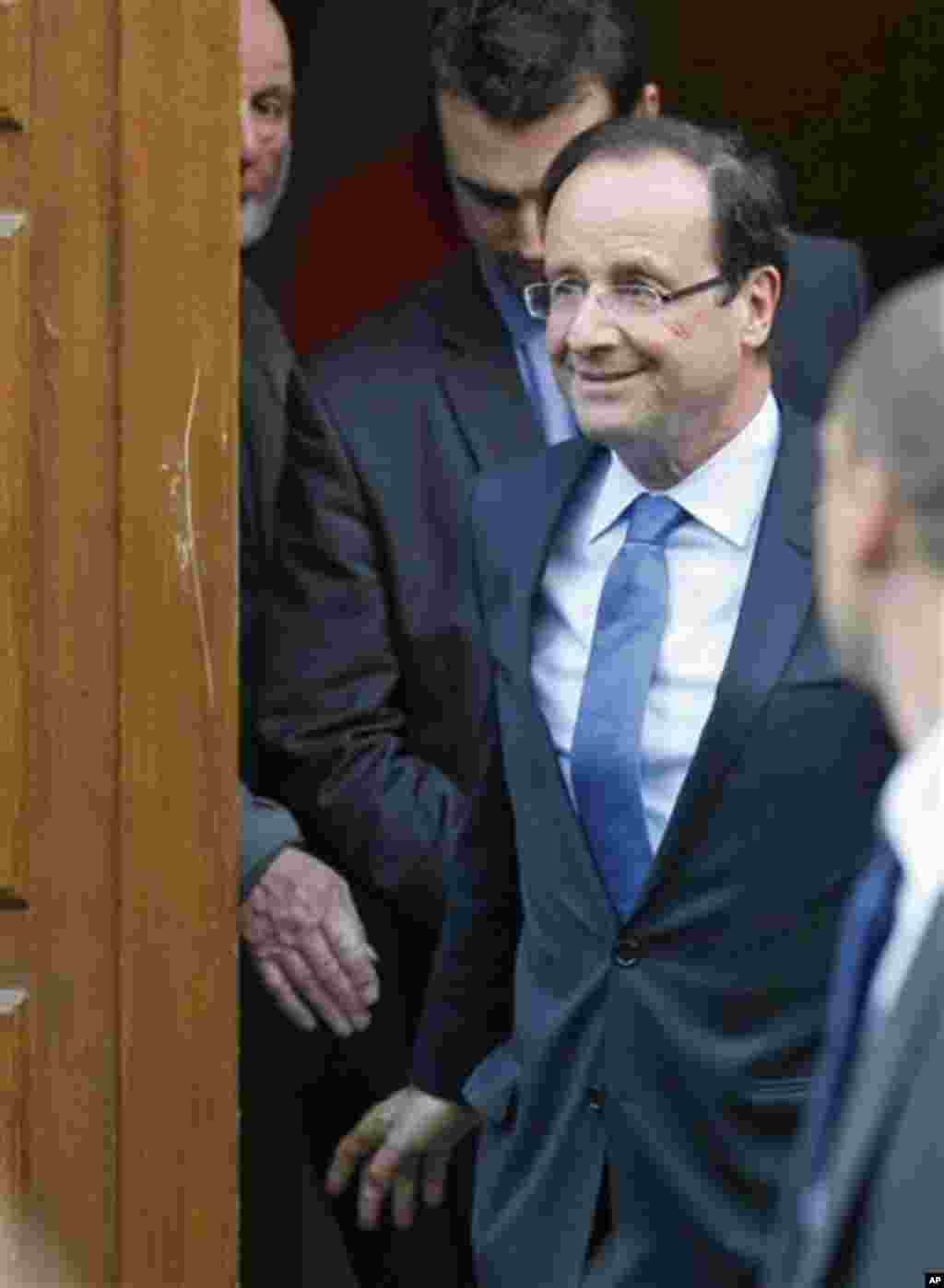 President-elect Francois Hollande leaves his campaign headquarters in Paris, Wednesday May 9, 2012. After winning the French Presidential Election, Hollande seems set to embark on a whirl-wind introduction to international politics, with critical visits 