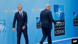 President Donald Trump walks away after being greeted by NATO Secretary General Jens Stoltenberg (L) before a summit of heads of state and government at NATO headquarters in Brussels on July 11, 2018.