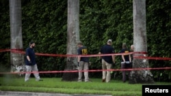 FILE - FBI officers search the perimeter of Trump International Golf Club after an apparent assassination attempt on Republican presidential nominee and former U.S. President Donald Trump at the course in West Palm Beach, Florida, Sept. 17, 2024. 