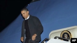 President Barack Obama steps off Air Force One, 04 Dec 2010, after his arrival at Andrews Air Force Base. Obama was returning from an unannounced trip to Afghanistan